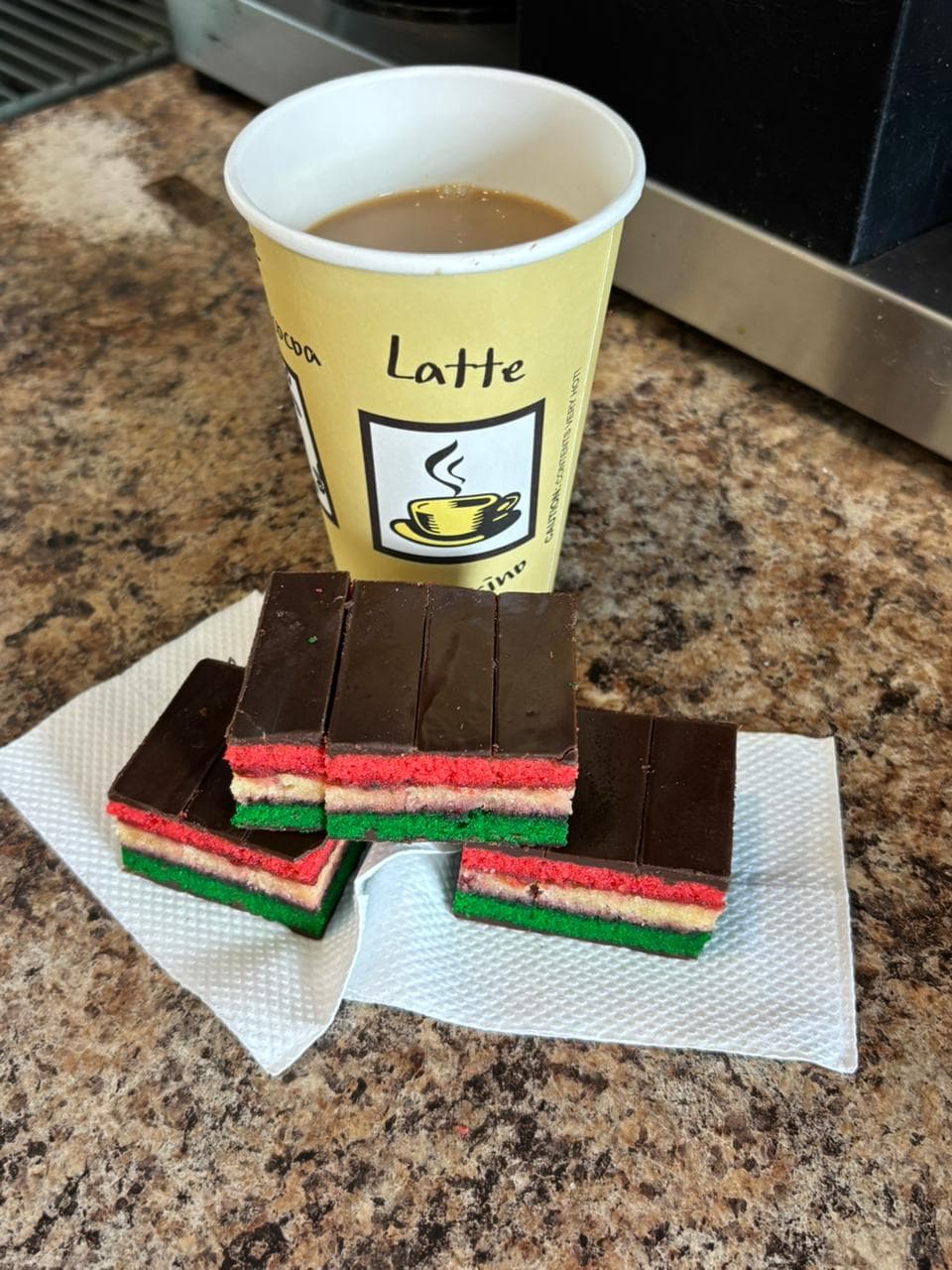 Rainbow cookie slices with a fresh latte