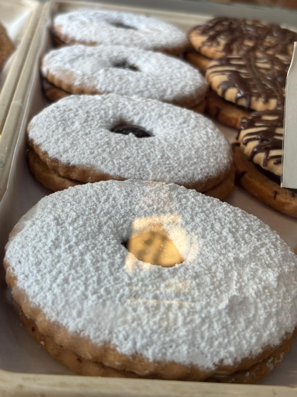 Powdered linzer cookies and chocolate-drizzled cookies
