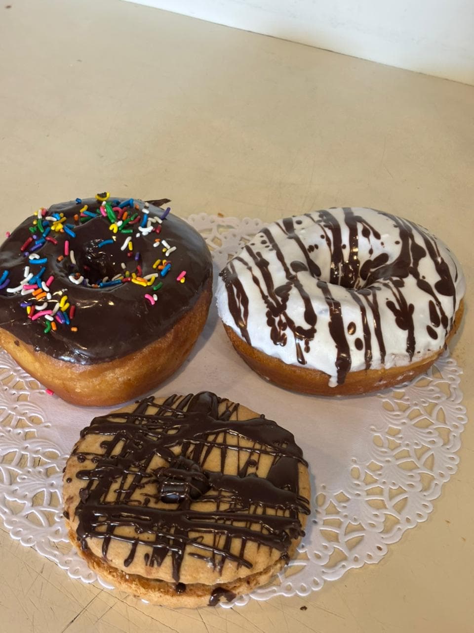 Chocolate-iced donuts on a doily