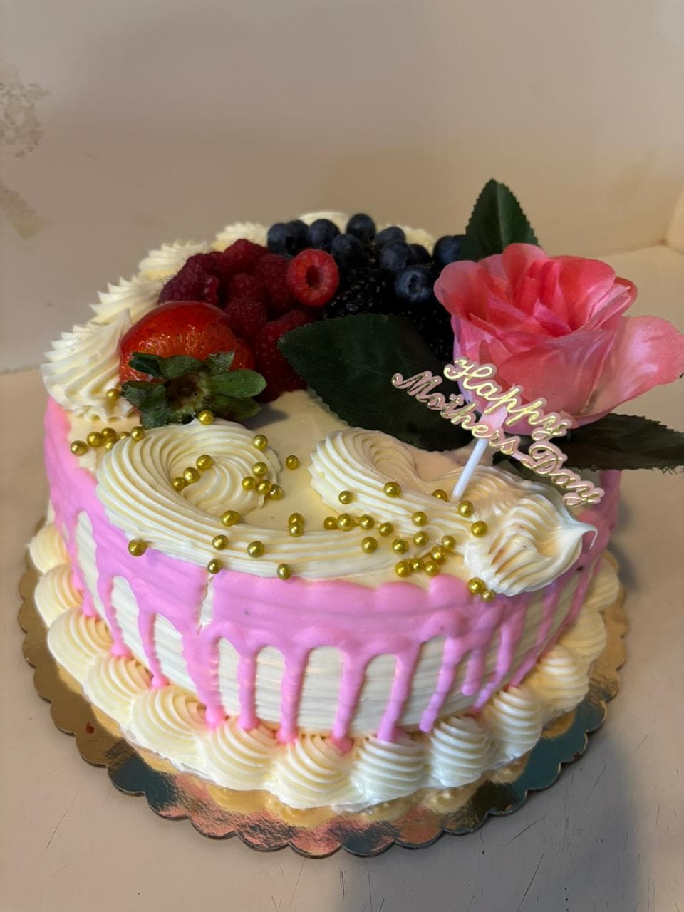 Pink drip cake with fresh flowers