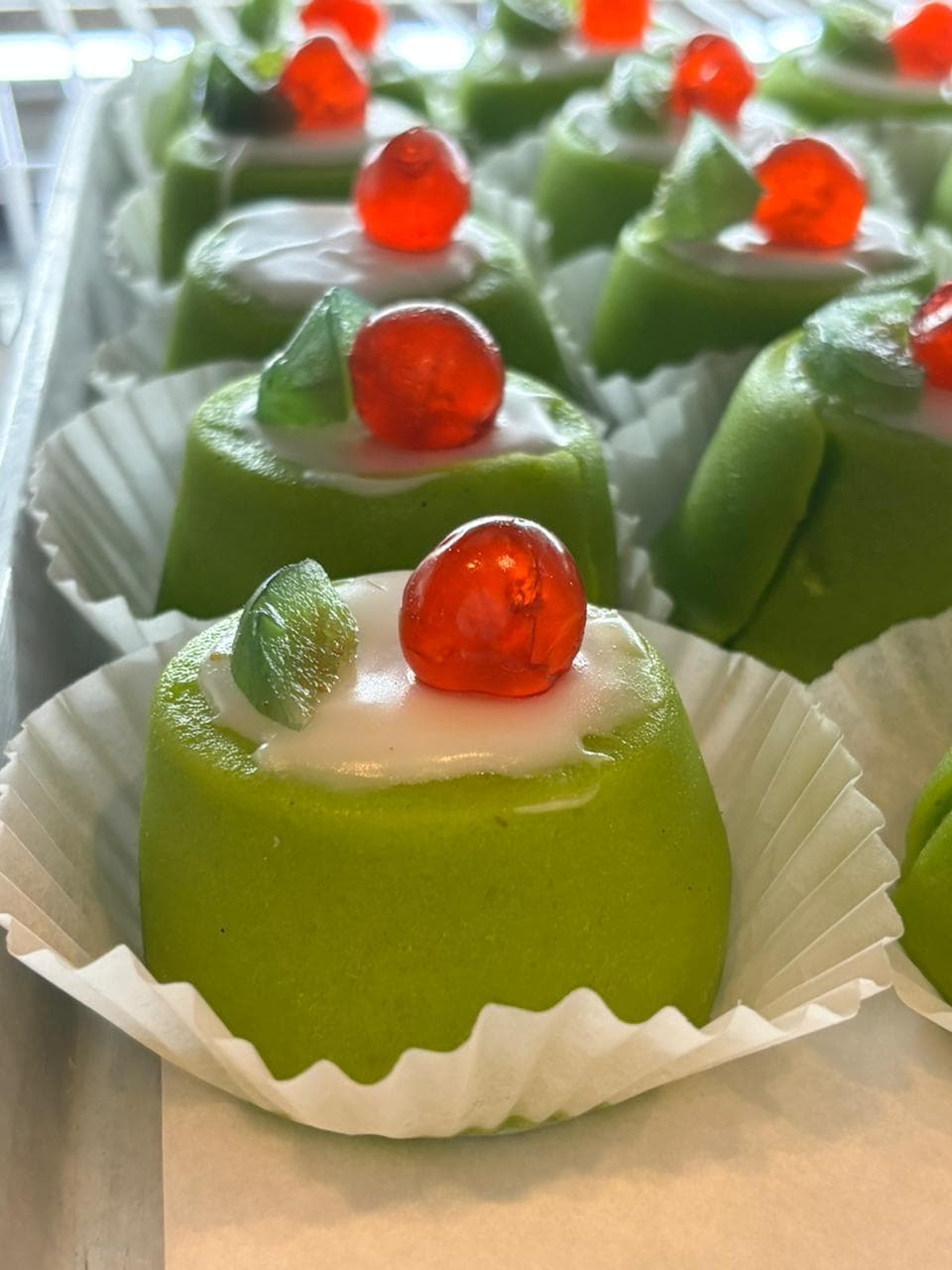 Green pistachio mini mousse cakes with cherries