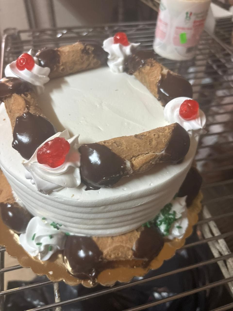 Whipped cream cake ringed with chocolate-covered cherries