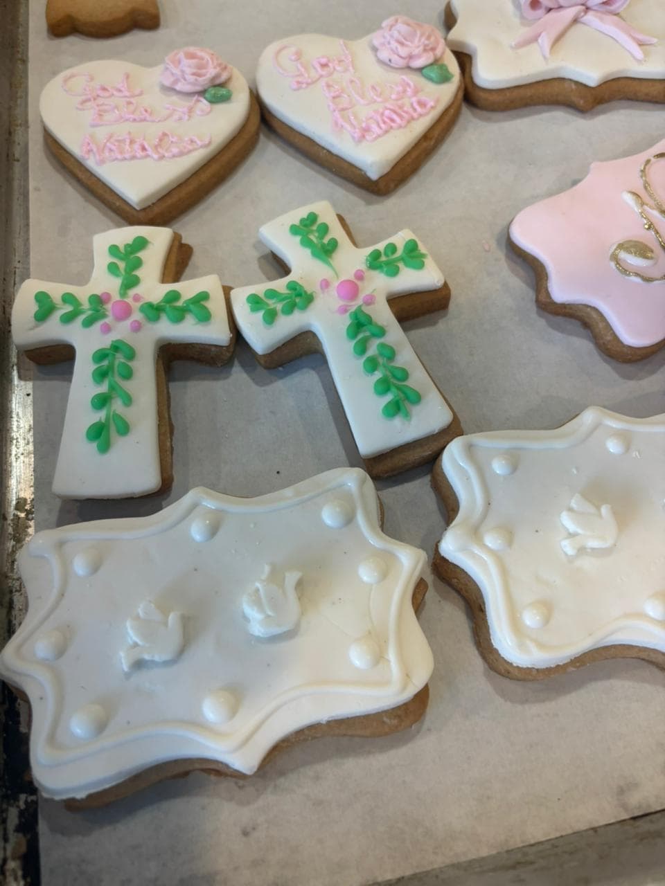 Hand-decorated cross and flower cookies