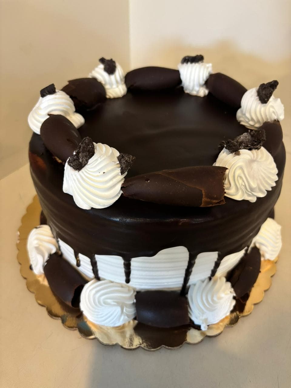 Chocolate ganache cake with whipped cream rosettes